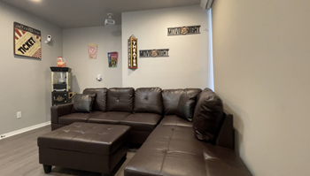 Entertainment room with leather sectional sofa